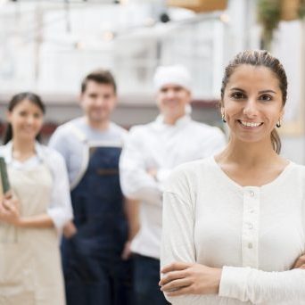 Business owner at a restaurant with her staff